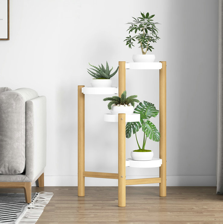 Modern wooden plant stand with white pots in a stylish living room.