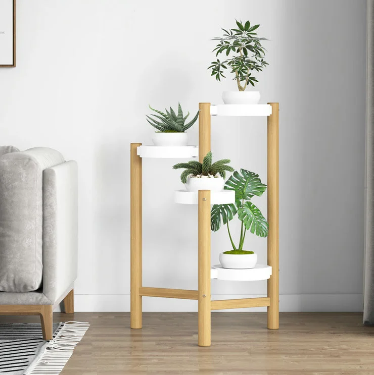 Modern wooden plant stand with white pots in a stylish living room.