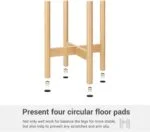 Wooden stool with four circular floor pads for stability and scratch prevention.