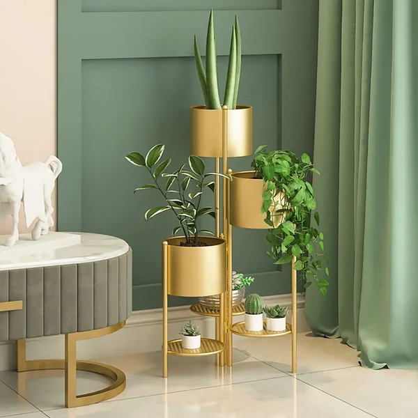 Modern gold indoor planters with green plants in a stylish living room.