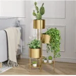 Modern gold indoor planters with various plants in a stylish living room setting.