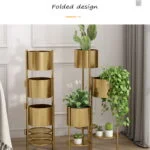 Gold metal indoor planters with plants in a modern home setting.