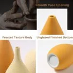 Close-up of modern ceramic vases with smooth opening and frosted texture.