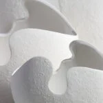 Close-up of modern white ceramic vase with textured surface, ideal for luxury home decor.