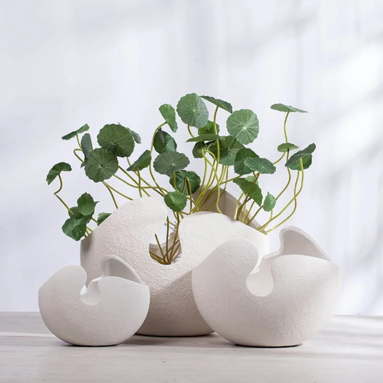 Modern decorative white ceramic vases with green plants for luxury home decor.