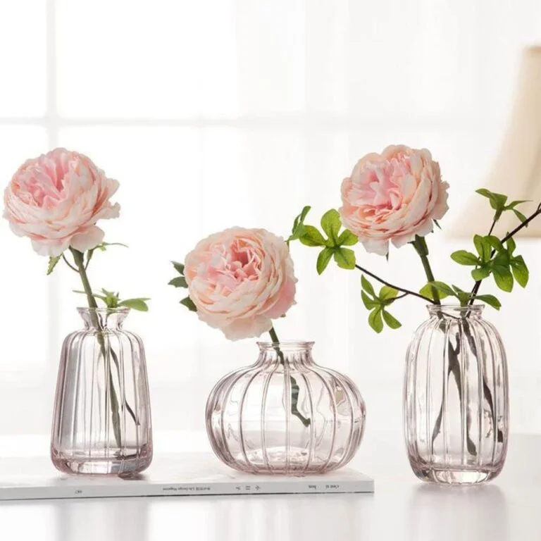 Elegant glass vases with pink flowers for modern home decor.