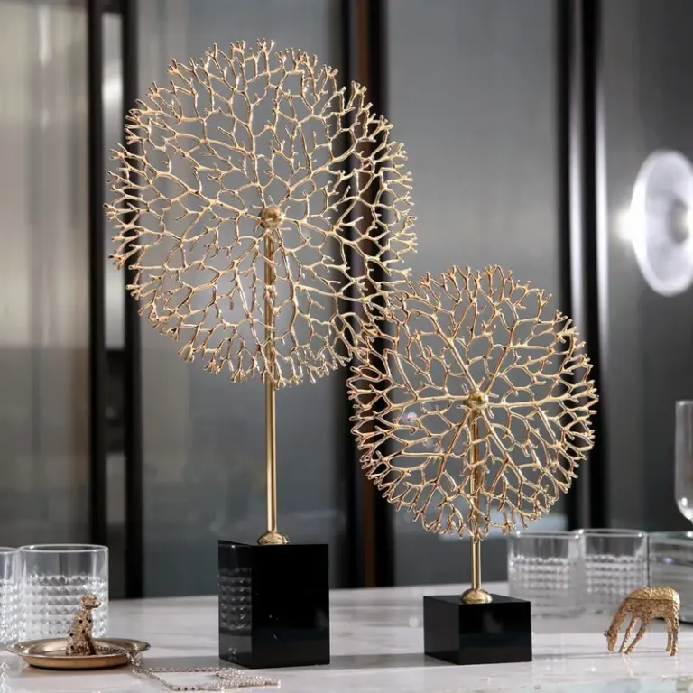 Gold decorative sculptures on black bases for modern home decor.