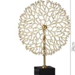 Gold decorative sculpture on black base, modern home decor accessory.