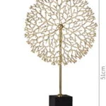 Gold decorative sculpture on black base, modern home decor accessory.