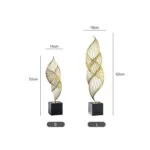 Gold decorative sculptures on black bases, modern home decor.