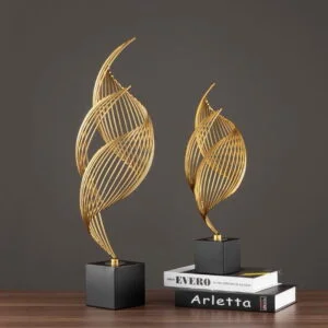Modern gold decorative sculptures on black bases, perfect for luxury home decor.