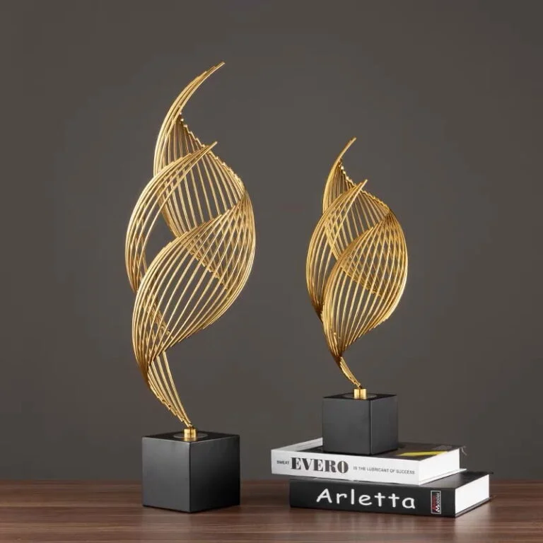 Modern gold decorative sculptures on black bases, perfect for luxury home decor.