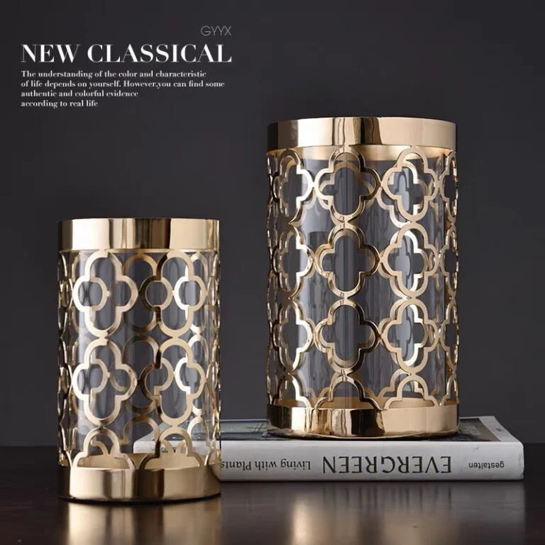 Elegant gold and glass decorative vases on a book, modern luxury home decor.