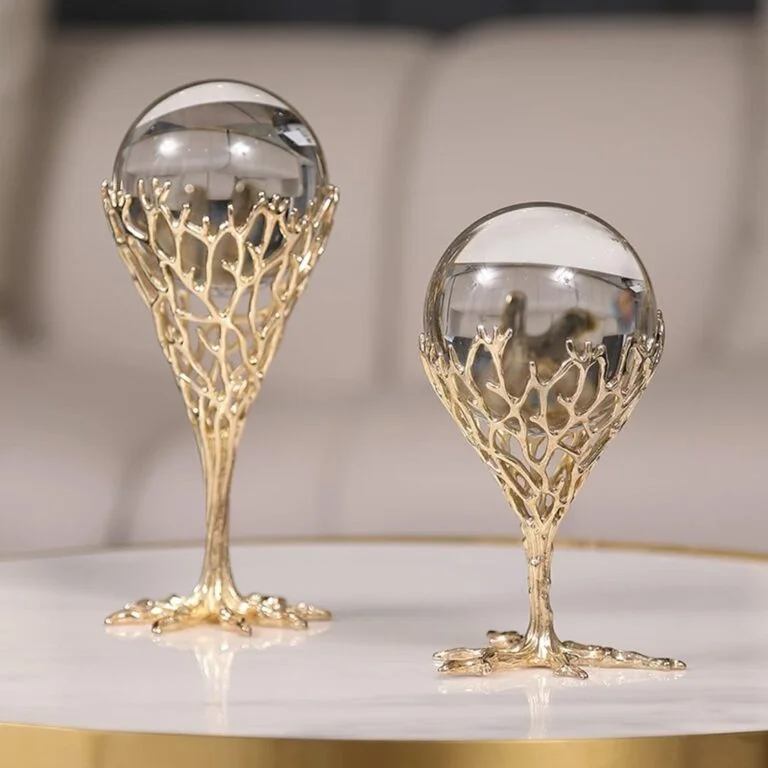 Elegant gold decorative ornaments with crystal spheres on a modern table.