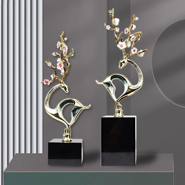 Elegant gold and black deer sculptures with floral accents for modern home decor.