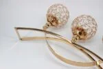 Gold decorative wall art with crystal accents, modern luxury home decor.