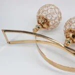 Elegant gold and crystal decorative wall art with modern design.