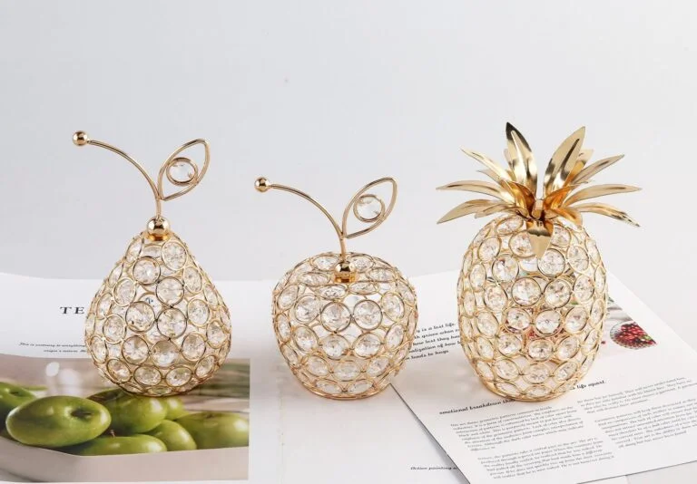 Elegant crystal fruit-shaped decorative ornaments on a table.