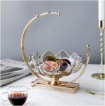 Elegant gold and glass fruit bowl on a marble table, modern home decor accessory.