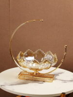 Elegant gold and glass decorative bowl on a marble table, perfect for luxury home decor.