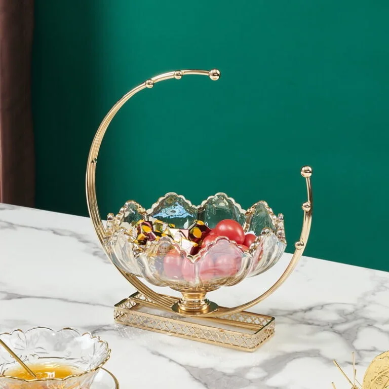 Elegant gold and crystal decorative bowl on marble table, modern home decor accessory.