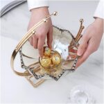 Elegant glass and gold decorative bowl with chocolates, perfect for luxury home decor.