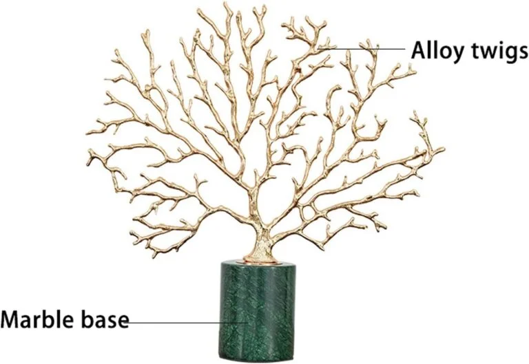 Gold alloy twig sculpture on a green marble base, modern decorative ornament.