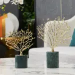 Gold decorative tree sculptures on marble bases for modern home decor.