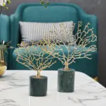 Gold decorative tree sculptures on marble base, modern home decor.