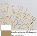 Gold decorative wall art with intricate branch design.