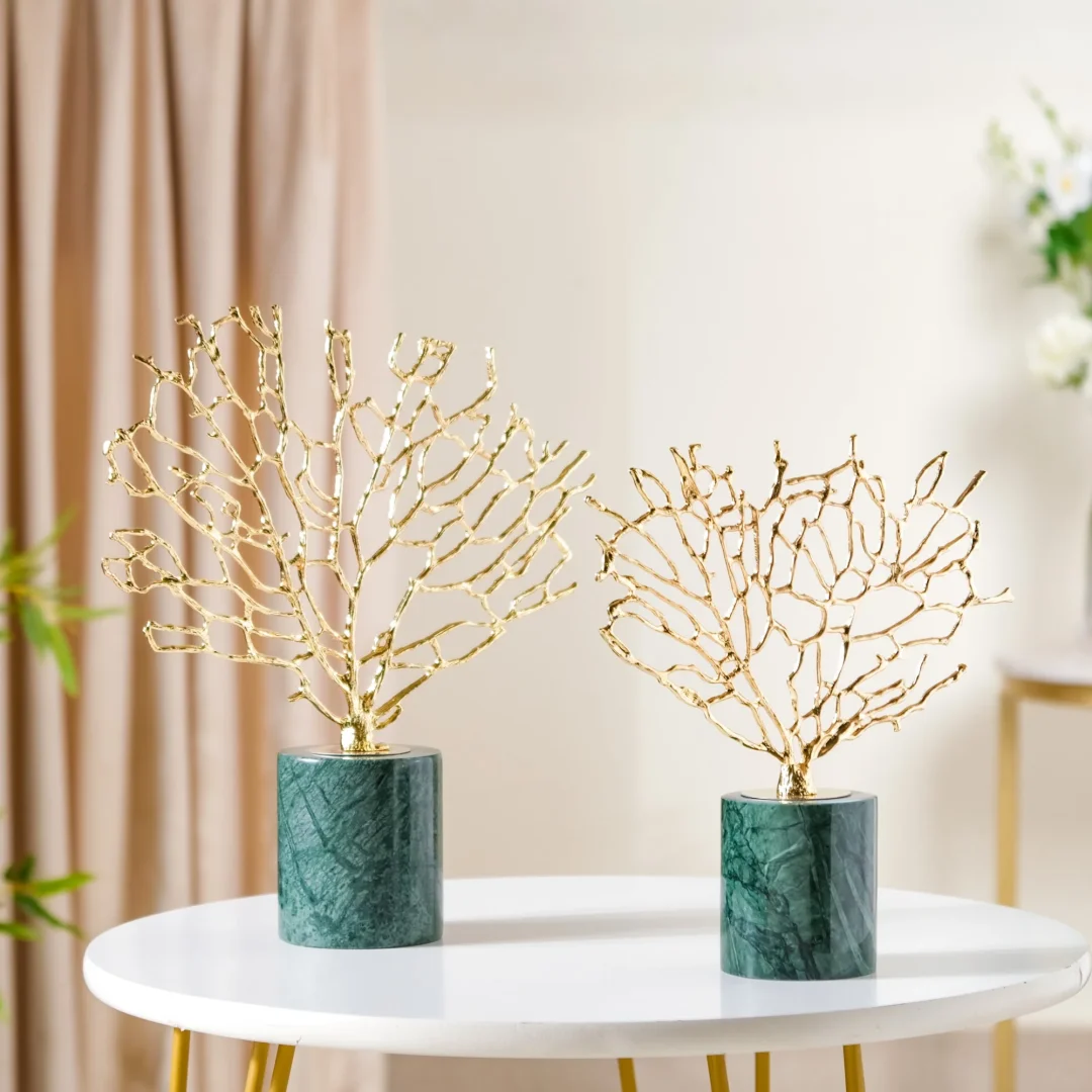 Gold Sculptures on Marble Base Gold decorative sculptures on a marble base, modern home decor.