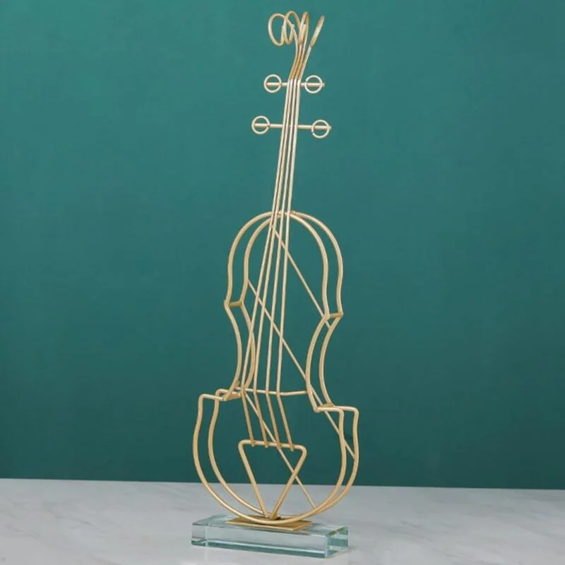 Gold wire violin sculpture on a glass base, modern home decor accessory.