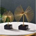 Gold decorative sculptures on a marble table, modern home decor.