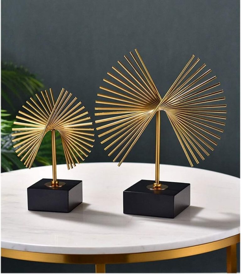 Gold decorative sculptures on a marble table, modern home decor.