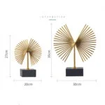 Gold decorative sculptures on black bases, modern home decor.