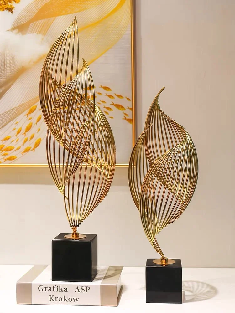 Elegant gold decorative sculptures on black bases, modern home decor.