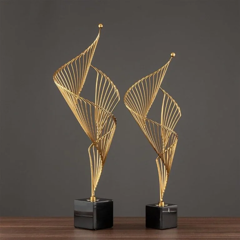 Elegant gold decorative sculptures on a dark base, perfect for modern luxury home decor.