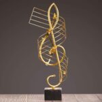 Gold decorative sculpture on a black base, modern home decor accent.