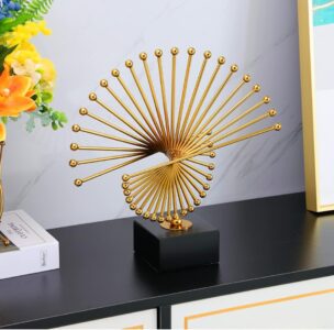 Gold spiral sculpture on black base, modern home decor accessory.