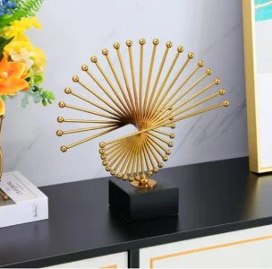 Gold spiral sculpture on black base, modern home decor accessory.