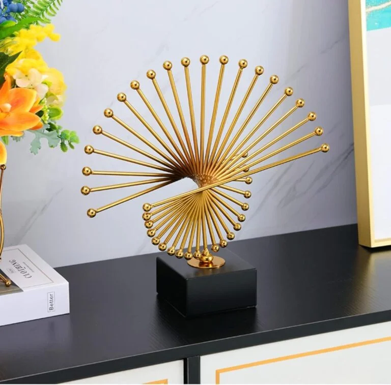 Gold spiral sculpture on black base, modern home decor accessory.
