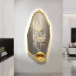 Illuminated deer wall art with gold frame in modern living room decor.