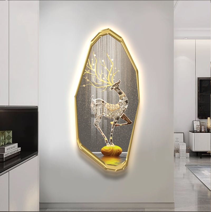 Illuminated deer wall art with gold frame in modern living room decor.