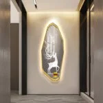 Illuminated wall art with deer silhouette in modern hallway decor.