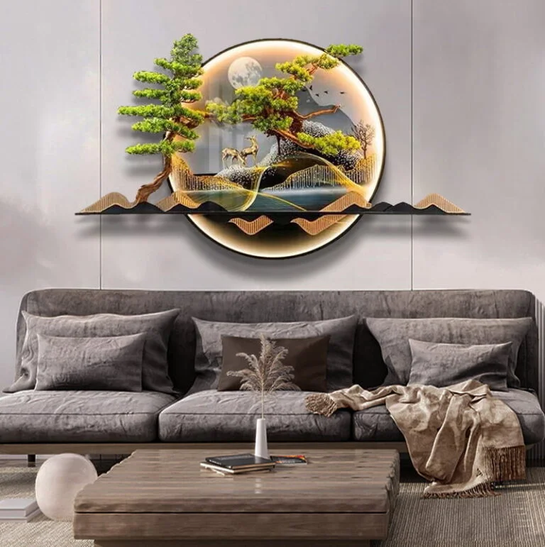 Modern illuminated wall art with nature scene above a grey sofa in a stylish living room.