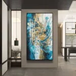 Modern luxury wall art with abstract design in blue and gold, framed and displayed in a contemporary interior.
