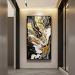 Modern abstract wall art with gold, black, and white swirls in a hallway.