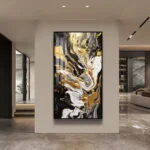 Modern luxury wall art with abstract gold and black design in a sleek interior setting.