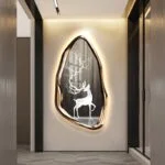 Illuminated modern wall art with deer design in luxury hallway decor.
