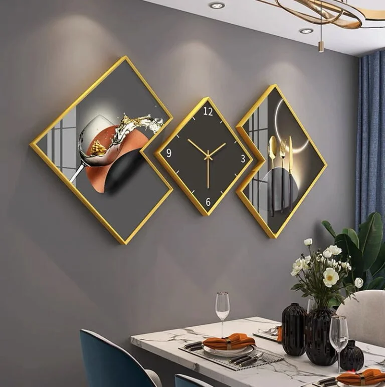Modern luxury wall art and clock set with gold frames in a dining room.